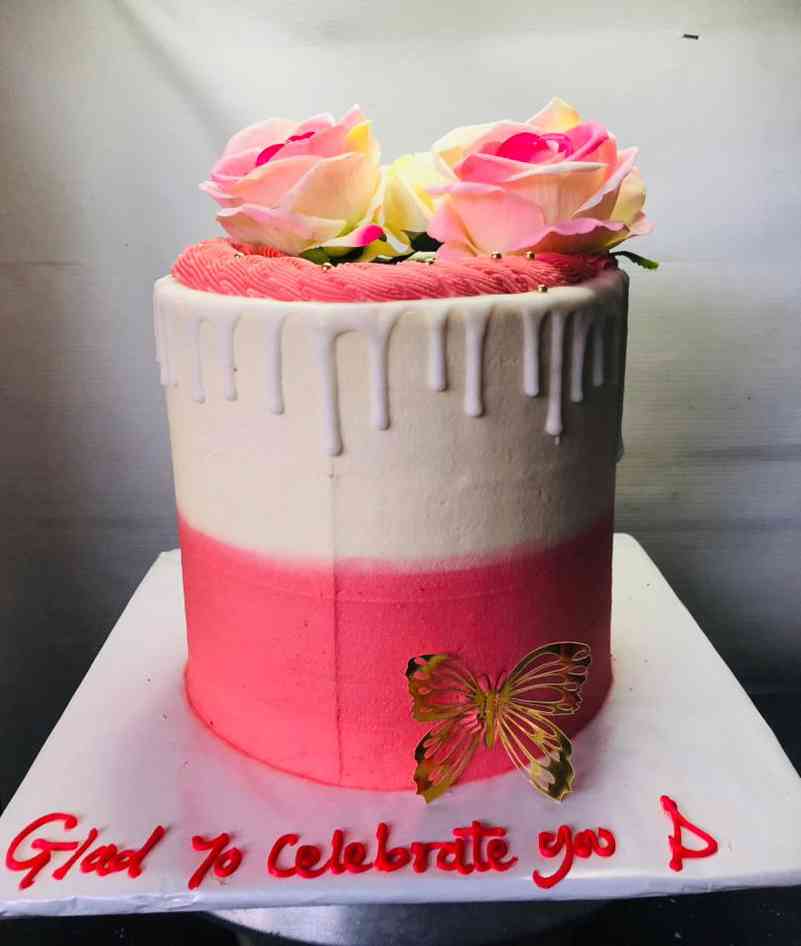 BIRTHDAY CAKE WITH PINK AND CREAM ICING....K