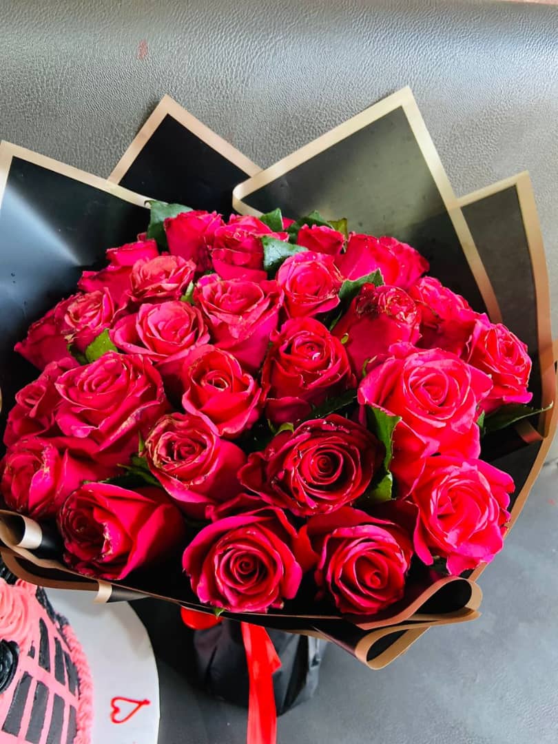 RED FLUFFY ROSES PACKAGED IN BLACK AND GOLD FLOWER COVER