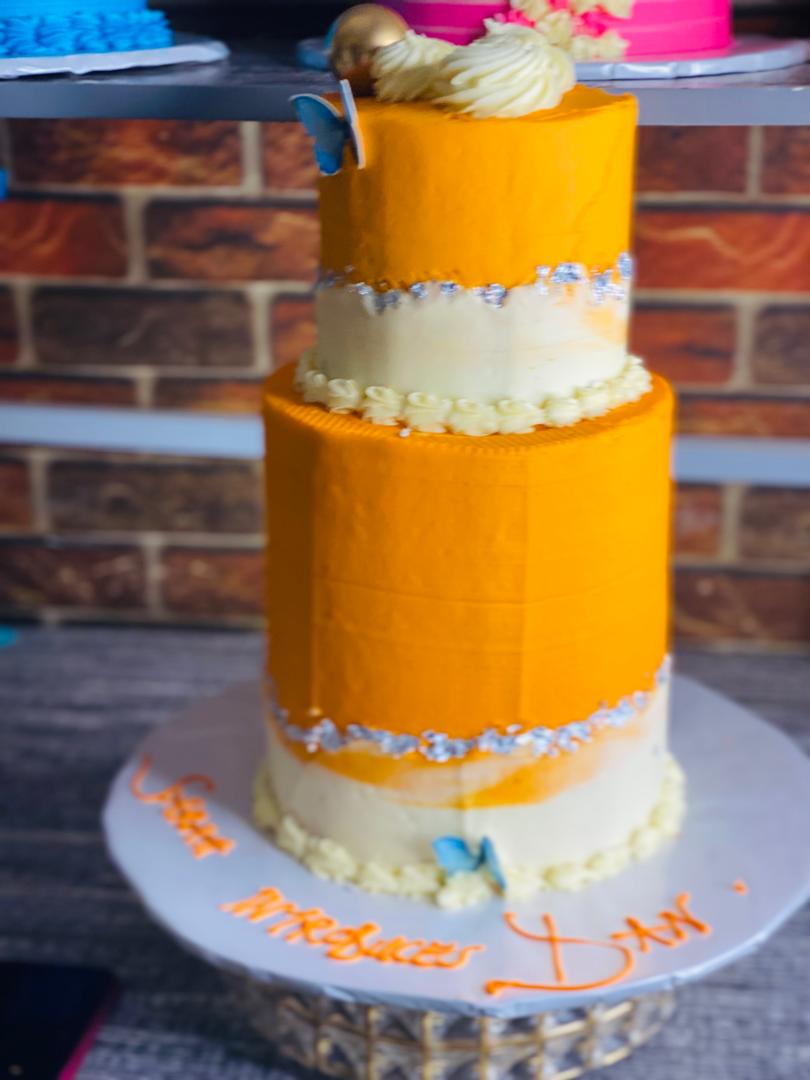 ORANGE AND CREAM BUTTER FLY TIRE BIRTHDAY CAKE 