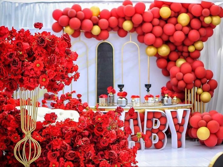 red and gold baby shower photo booth 