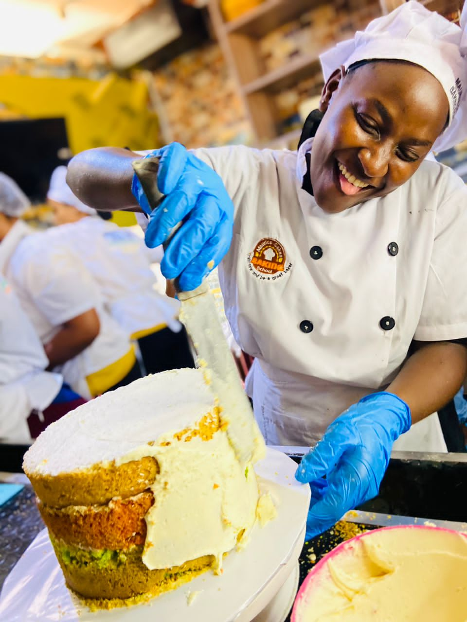 Look at the joy of having to lay a cake with our student Gladys 