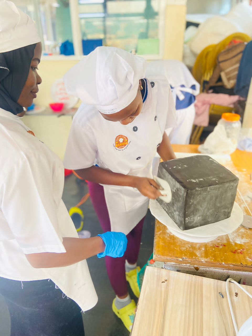 Our student Lairah having a try on the square cake 