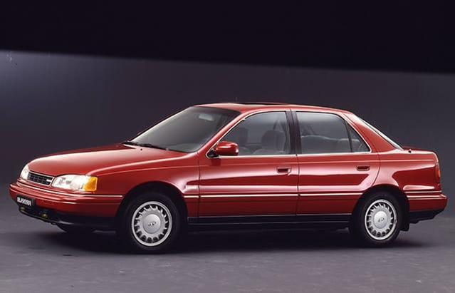 The first-generation J1 Elantra launched in 1990, featuring Mitsubishi-derived technology and practical proportions.