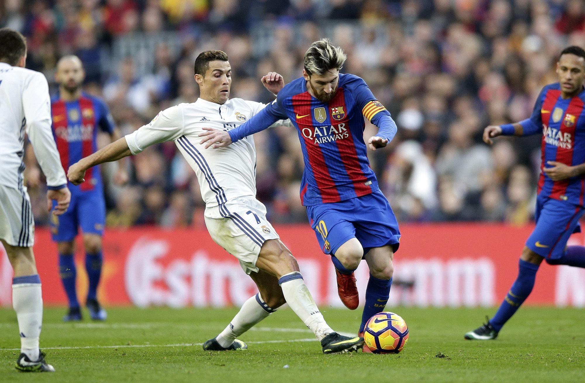 Lionel Messi and Cristiano Ronaldo, two football legends, sharing the pitch.