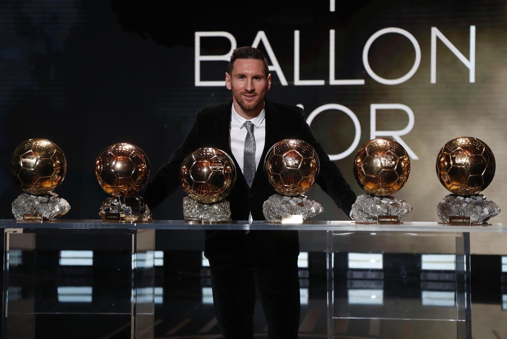 Lionel Messi posing with his record-breaking Ballon d'Or trophy.