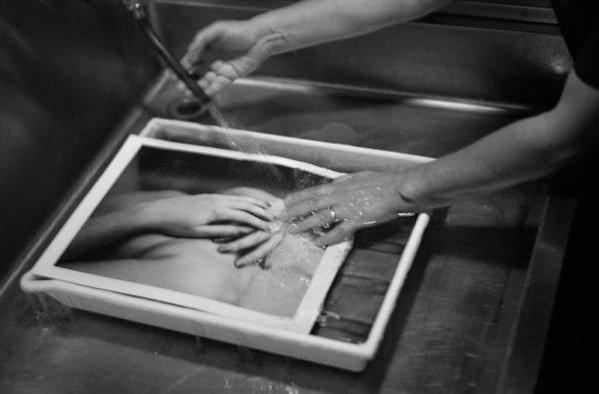 The physical texture and choice of printing materials are vital to conveying the warmth and emotional depth of Yook's work.