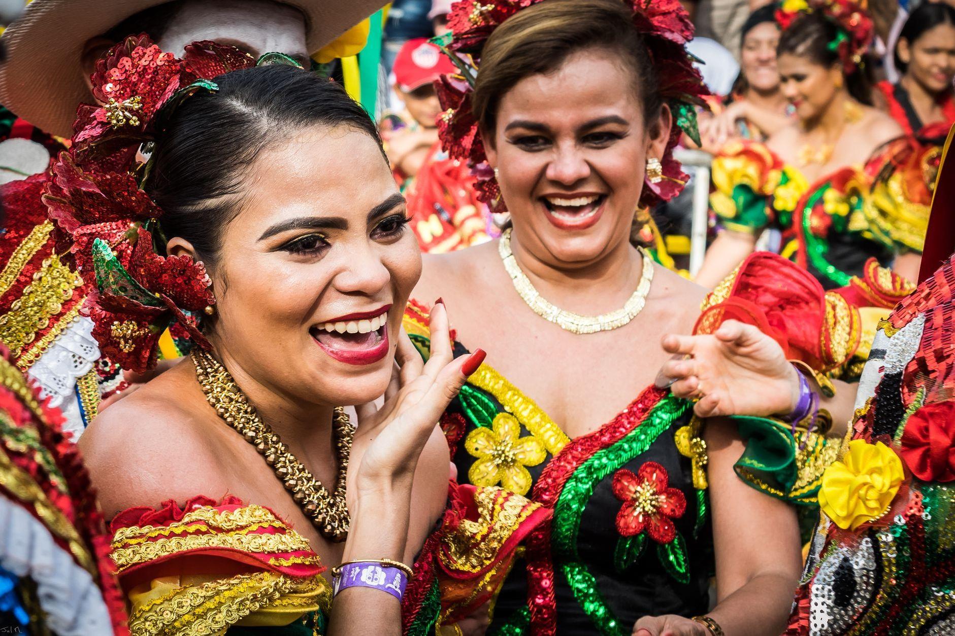 General visual reference for Early Life and Multicultural Roots. Source: Pexels / Photo by HERNAN PERNETT / Pexels License / https://www.pexels.com/photo/woman-in-red-and-green-floral-dress-smiling-7861553/