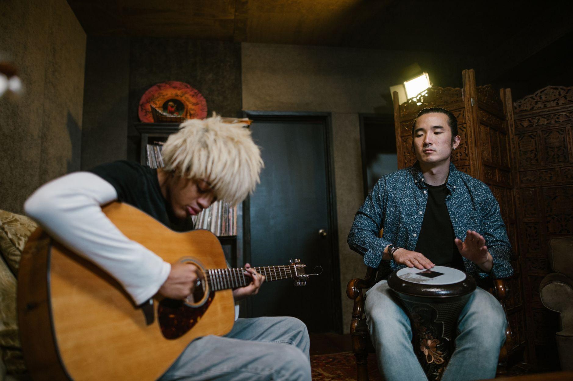 General visual reference for Musical Style and Genre-Blending Artistry. Source: Pexels / Photo by RDNE Stock project / Pexels License / https://www.pexels.com/photo/two-men-playing-music-instrument-8198122/