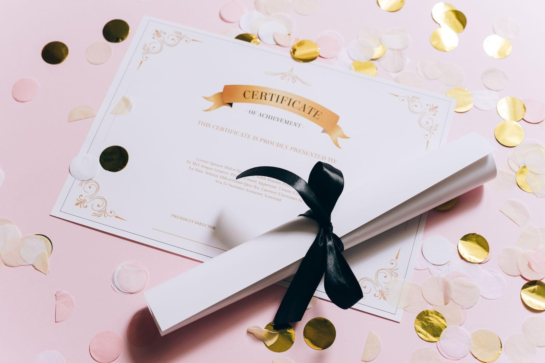 General visual reference for Honors and Public Recognition. Source: Pexels / Photo by Leeloo The First / Pexels License / https://www.pexels.com/photo/rolled-white-paper-and-a-certificate-on-a-pink-surface-8177922/