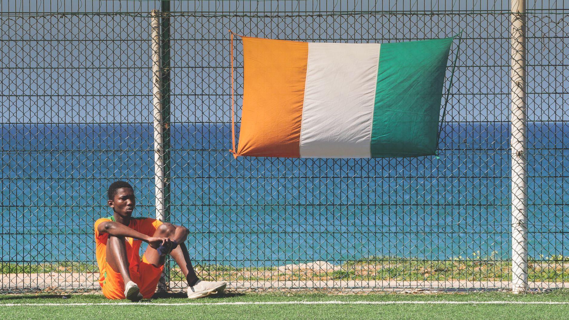 General visual reference for International Debut and Early National Team Career. Source: Pexels / Photo by rachid Azzouzy / Pexels License / https://www.pexels.com/photo/young-footballer-resting-by-ivory-coast-flag-on-field-30320486/