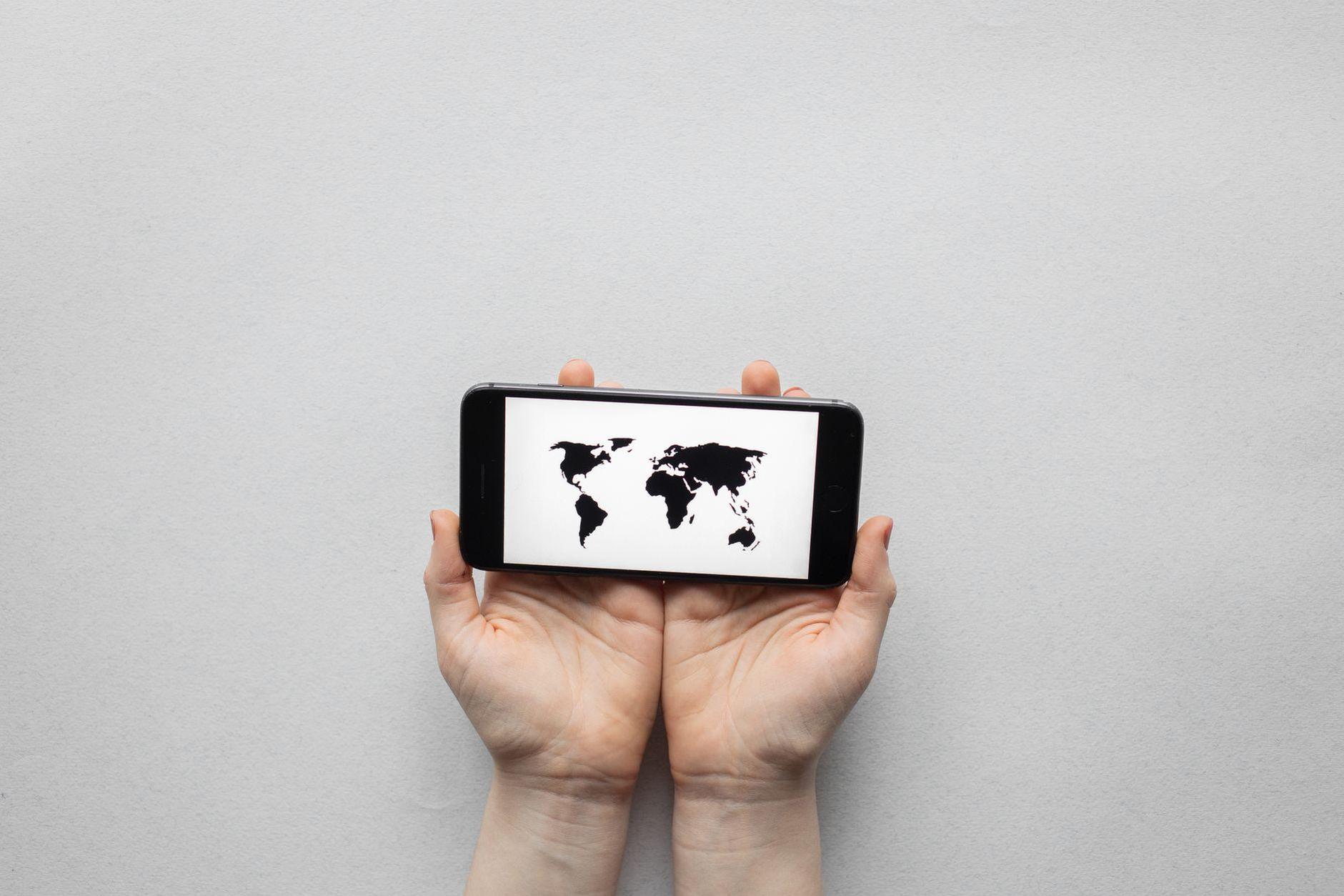 General visual reference for Localization and the Art of Cultural Translation. Source: Pexels / Photo by Monstera Production / Pexels License / https://www.pexels.com/photo/person-holding-a-black-smartphone-7411941/