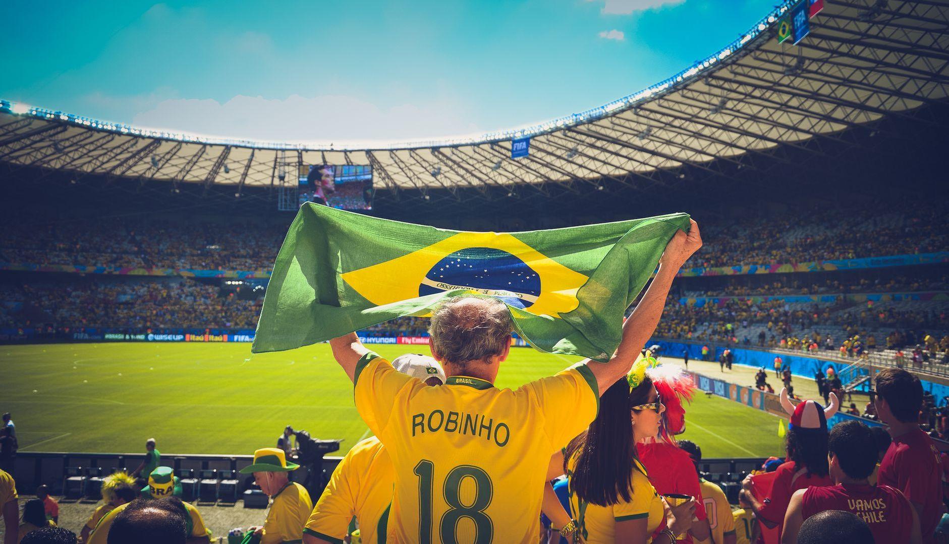 General visual reference for The Golden Era of the Messi Rivalry. Source: Pexels / Photo by Caio / Pexels License / https://www.pexels.com/photo/man-raising-brazil-flag-inside-football-stadium-58461/