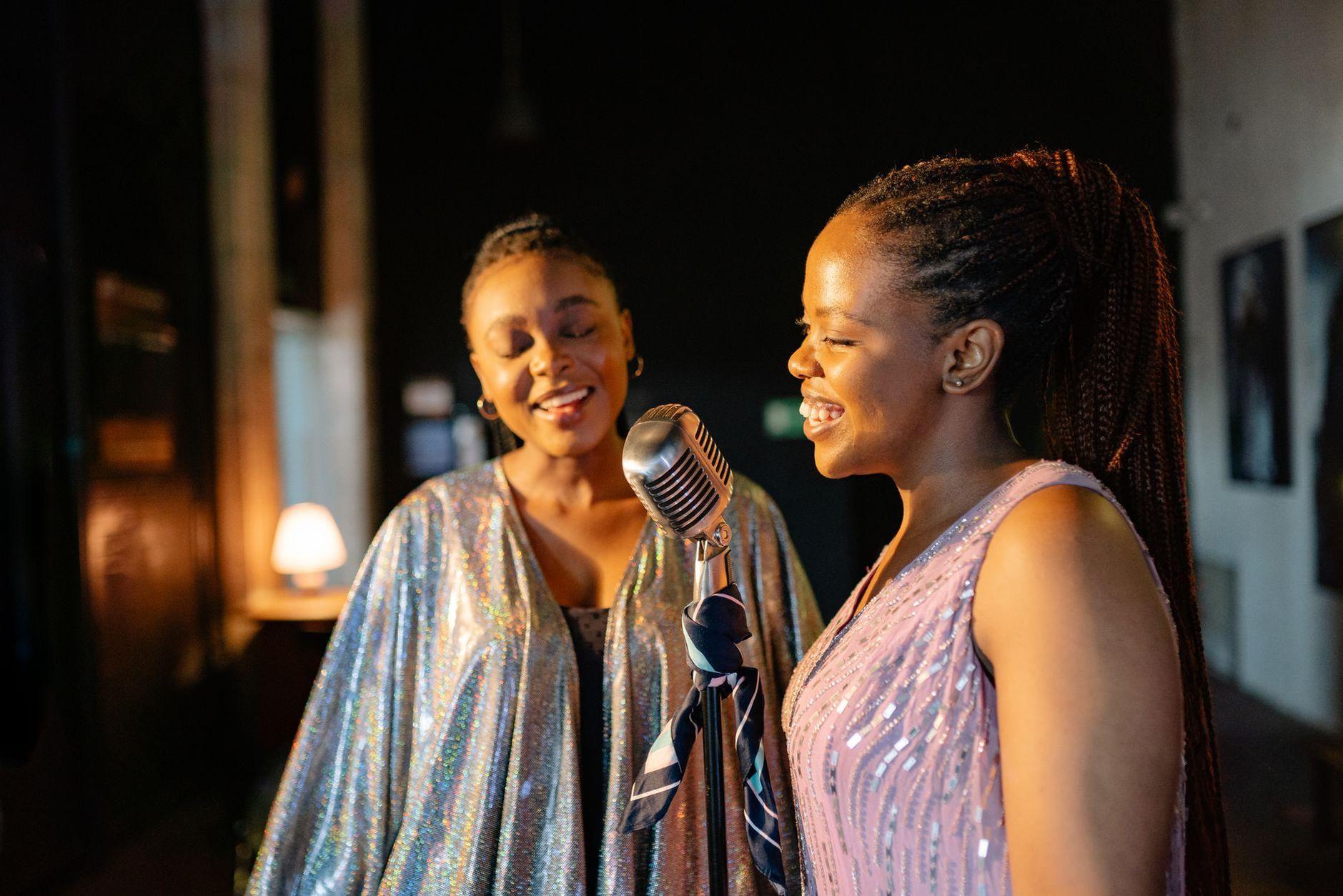 General visual reference for Collaborative Ventures and Joint Concerts. Source: Pexels / Photo by Yan Krukau / Pexels License / https://www.pexels.com/photo/two-woman-singing-9002785/