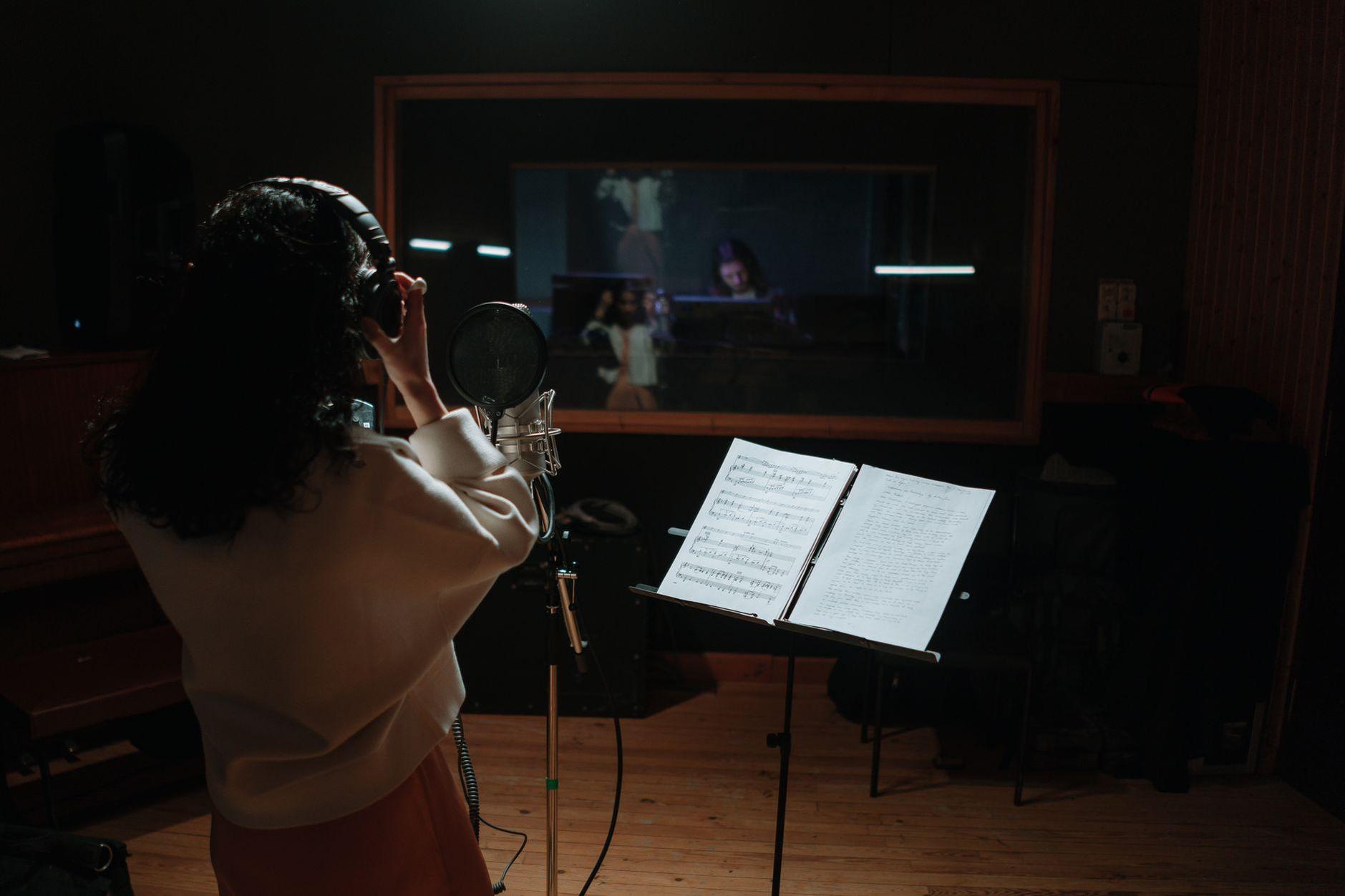 General visual reference for Early Struggles and Passion for Music. Source: Pexels / Photo by cottonbro studio / Pexels License / https://www.pexels.com/photo/back-view-of-a-woman-recording-a-song-in-a-music-studio-7086742/
