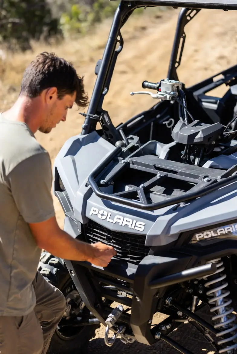 Buyer inspecting Polaris UTV frame and VIN plate before purchase