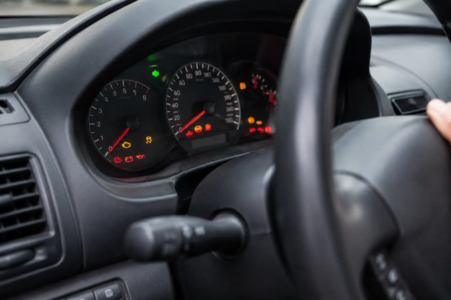Used car buyer checking the SRS airbag warning light on an instrument cluster