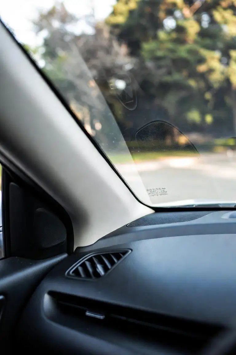 Mazda VIN number visible through windshield on driver's side dashboard Placement: Inline, after "How to Read a Mazda VIN — Breakdown by Position" table