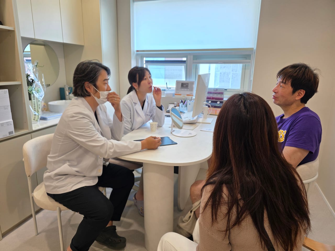 Steven at a consultation in Korea, sitting across from the medical team