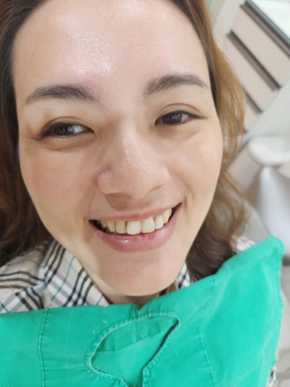 Nicole in the treatment chair at the dental clinic in Korea, smiling