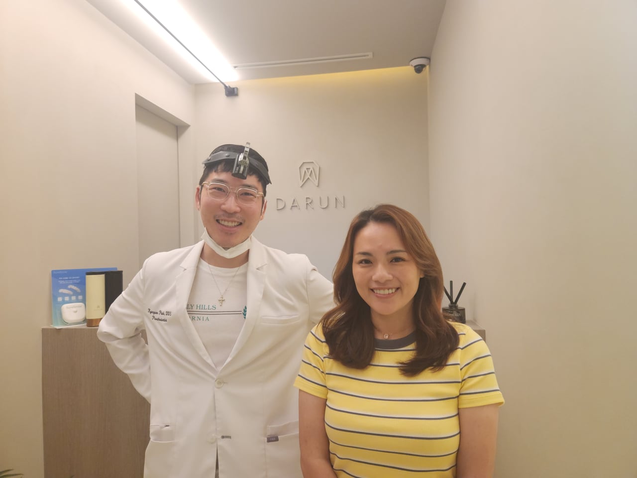 Nicole standing next to her dentist at the clinic