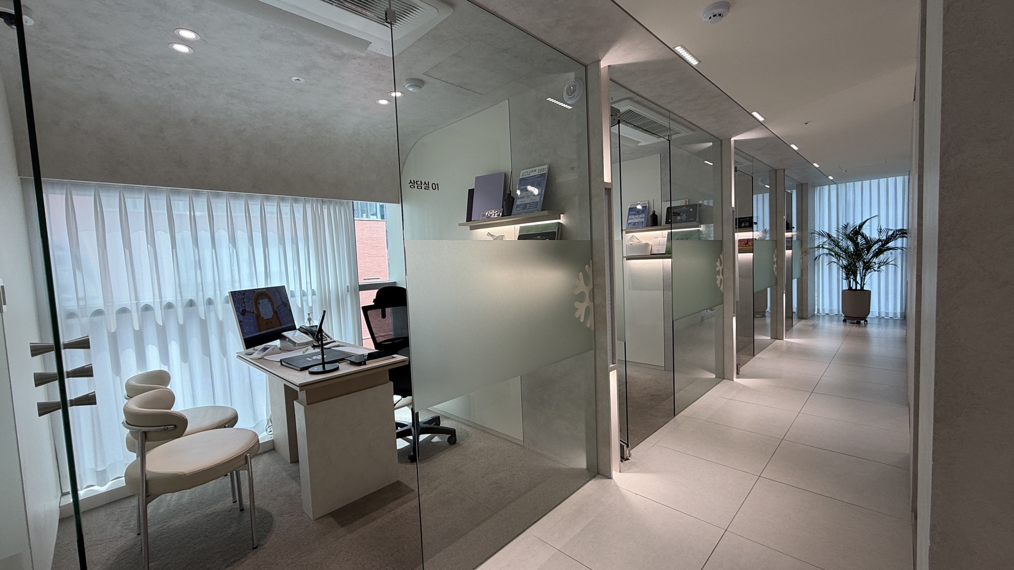 Consultation room enclosed by frosted glass partitions