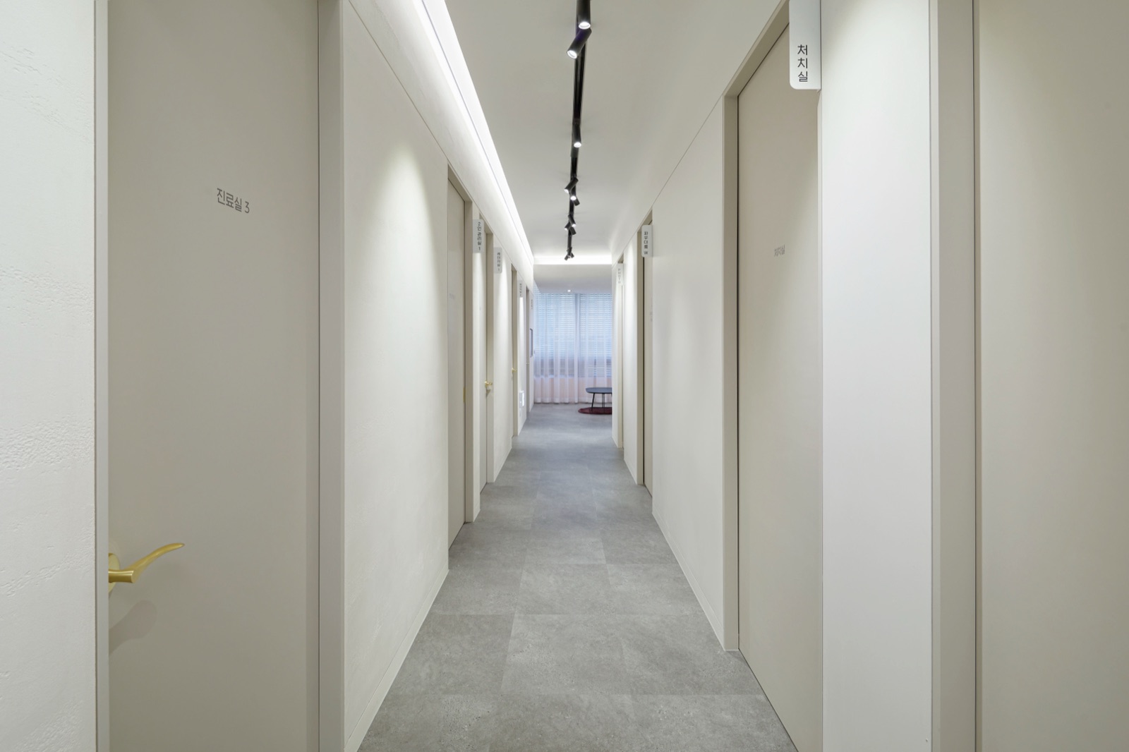 Corridor lined with examination and treatment room doors