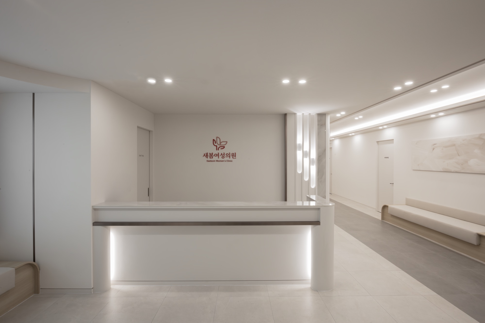 Reception desk with the clinic logo on the wall behind it
