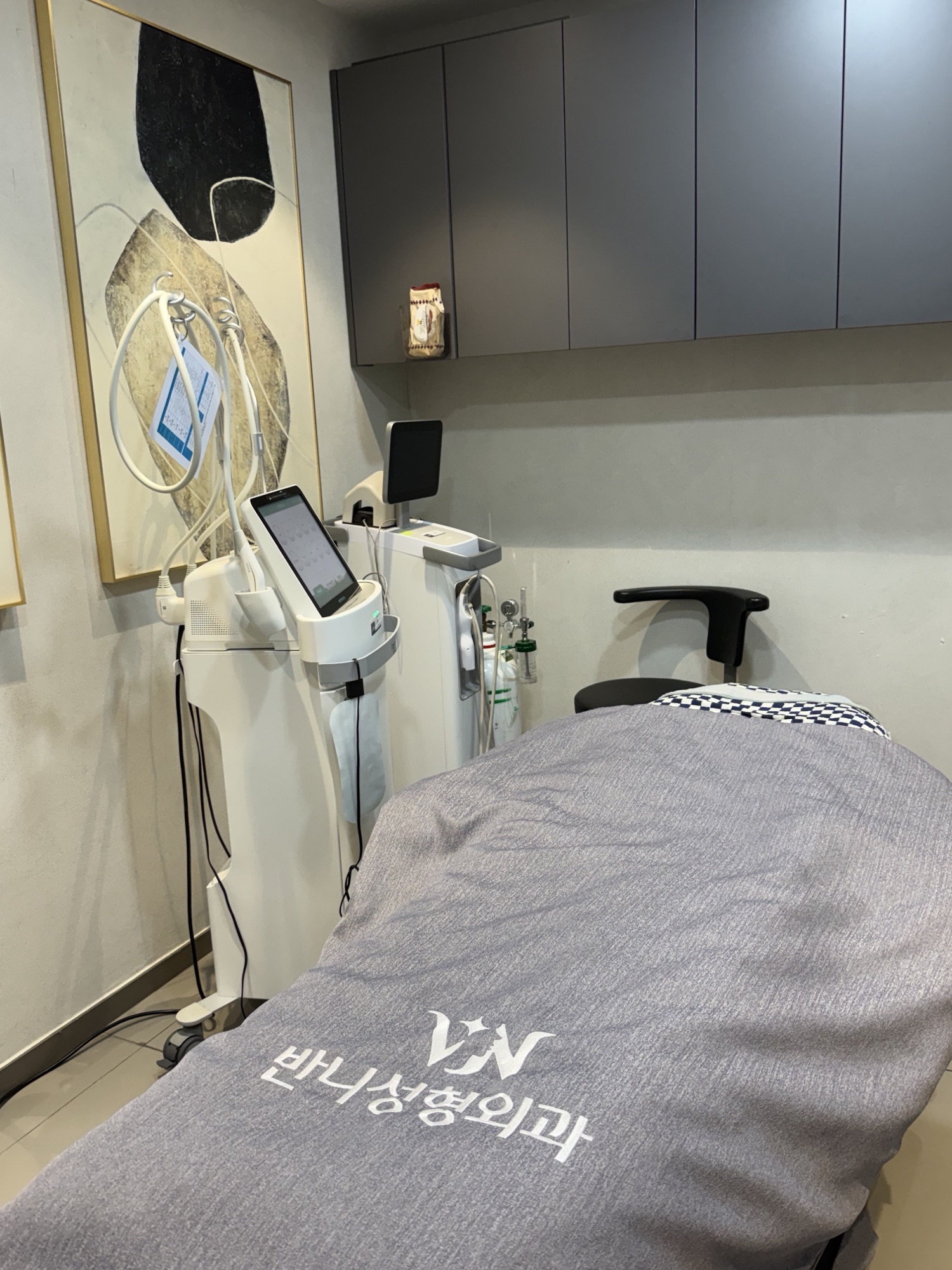 Procedure room with a treatment bed and laser equipment