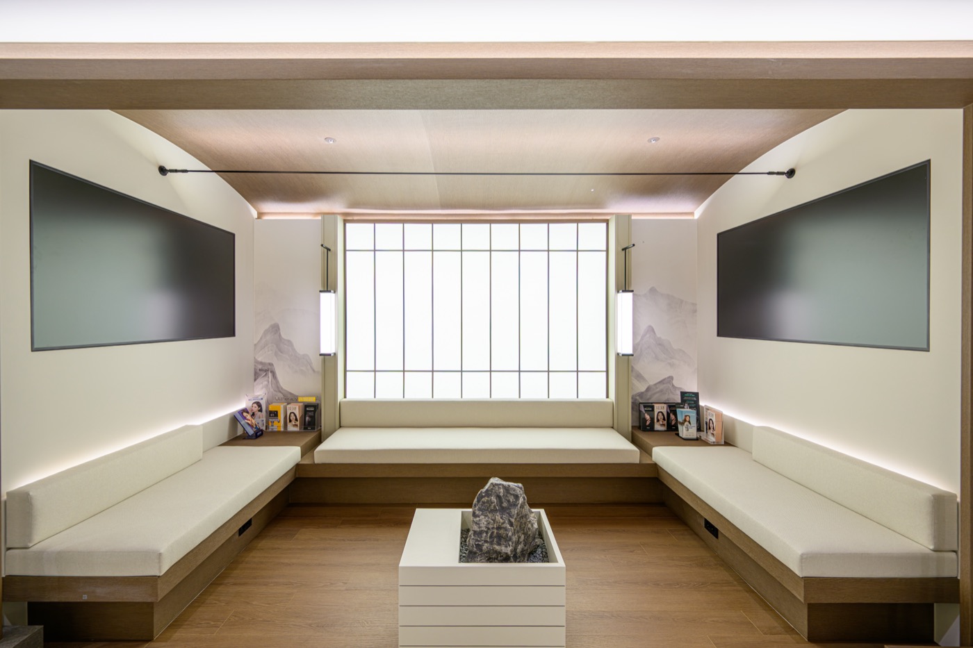 Waiting lounge with a backlit lattice window and bench seating along both walls