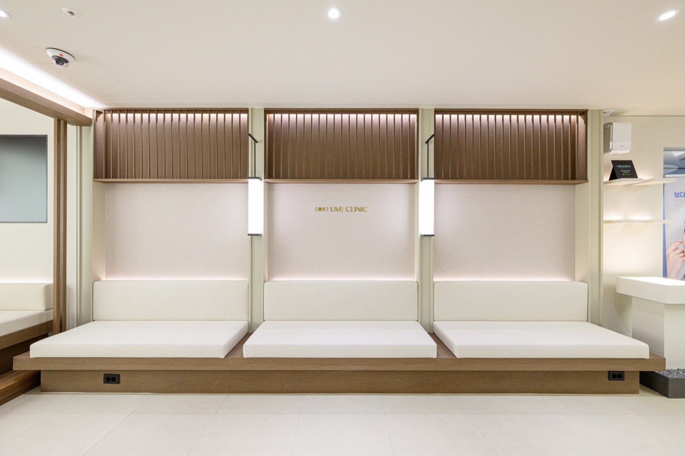 Three bench seats set against a wood-slat wall