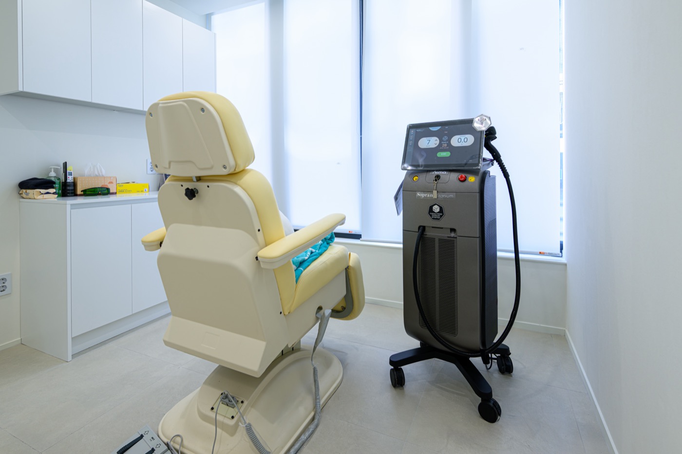 Treatment room with a reclining chair beside a mobile treatment device