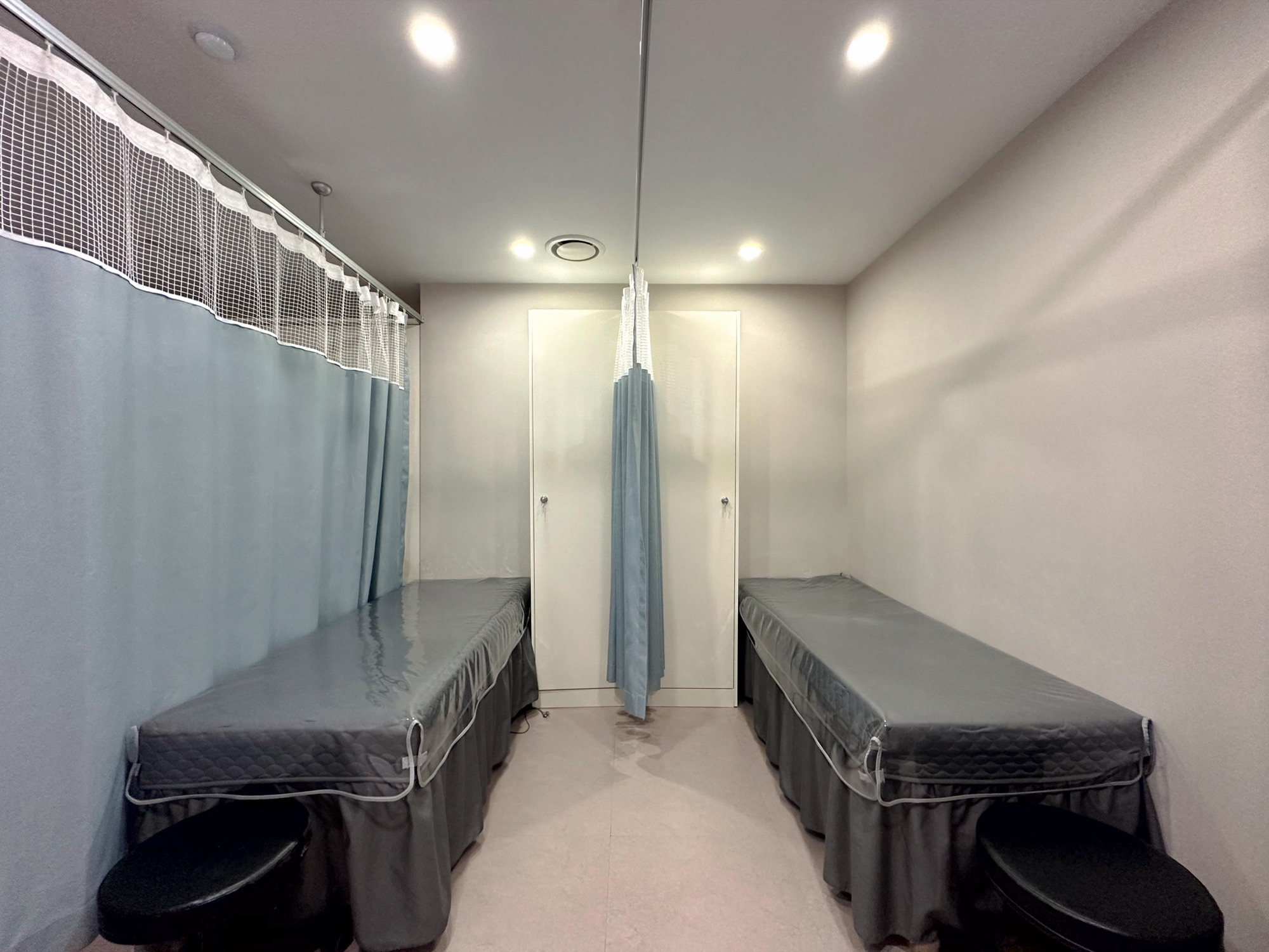 Recovery area with two beds separated by curtains