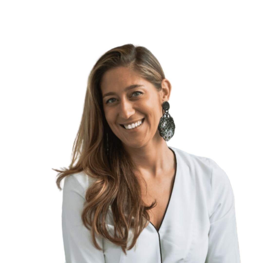 Marine smiling, with long brown hair, a white blouse and large dark earrings against a plain white background.