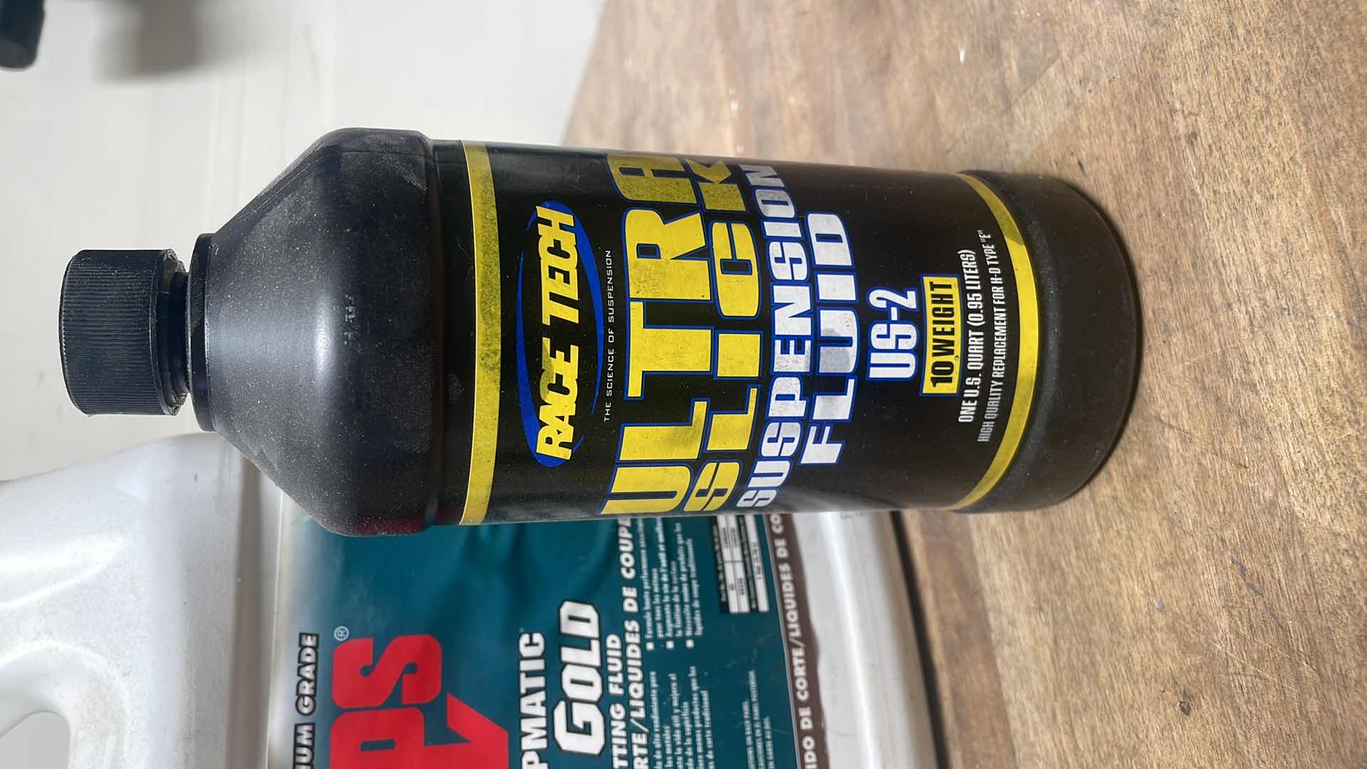 Photo 6 of MISC FLUIDS IN A GRAY PLASTIC CONTAINER SUSPENSION FLUID ABOUT 1/3 FULL