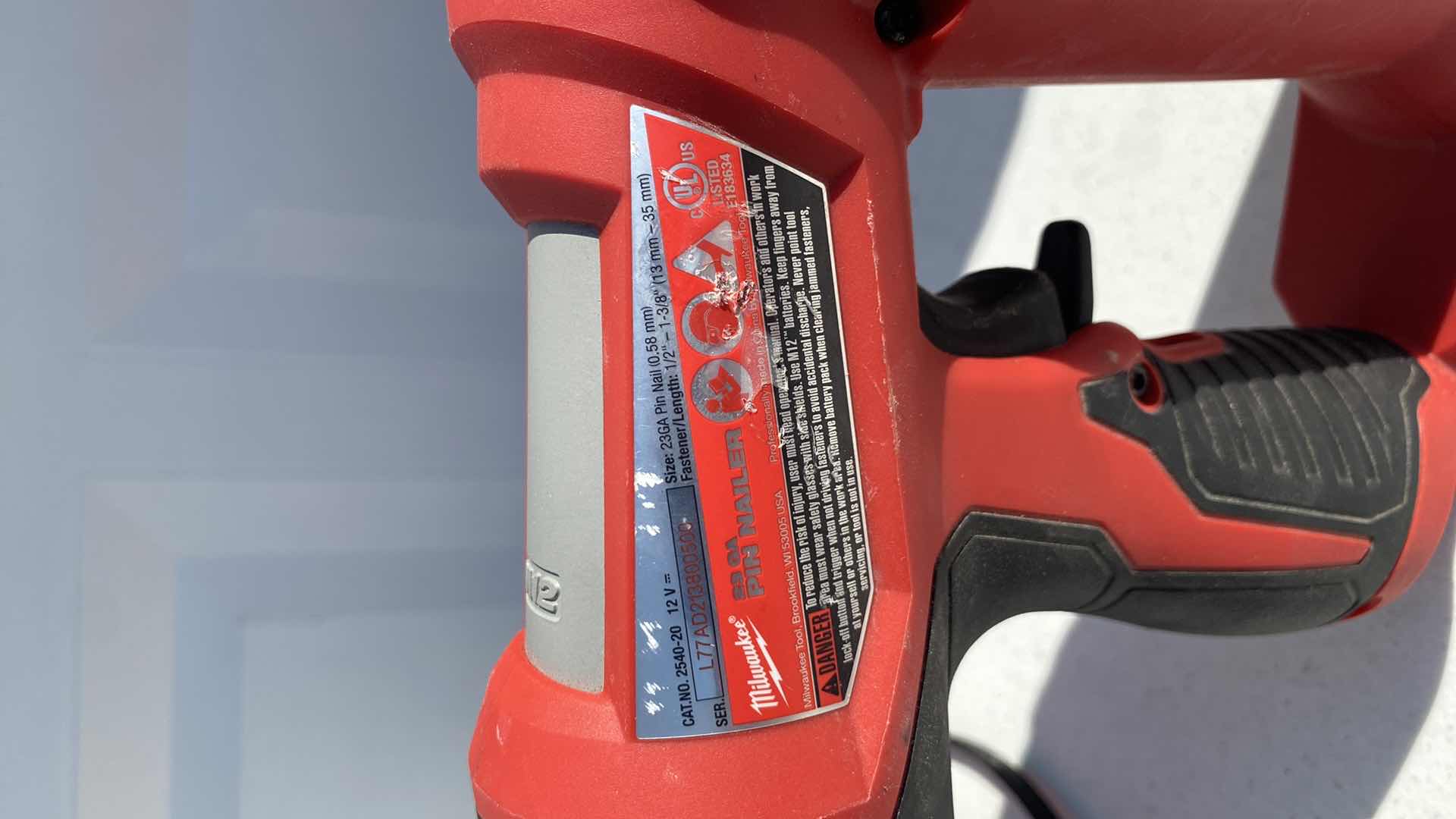 Photo 1 of MILWAULKEE 23GA PIN NAIL GUN 
BATTERY AND CHARGER INCLUDING 
TESTED WORKING