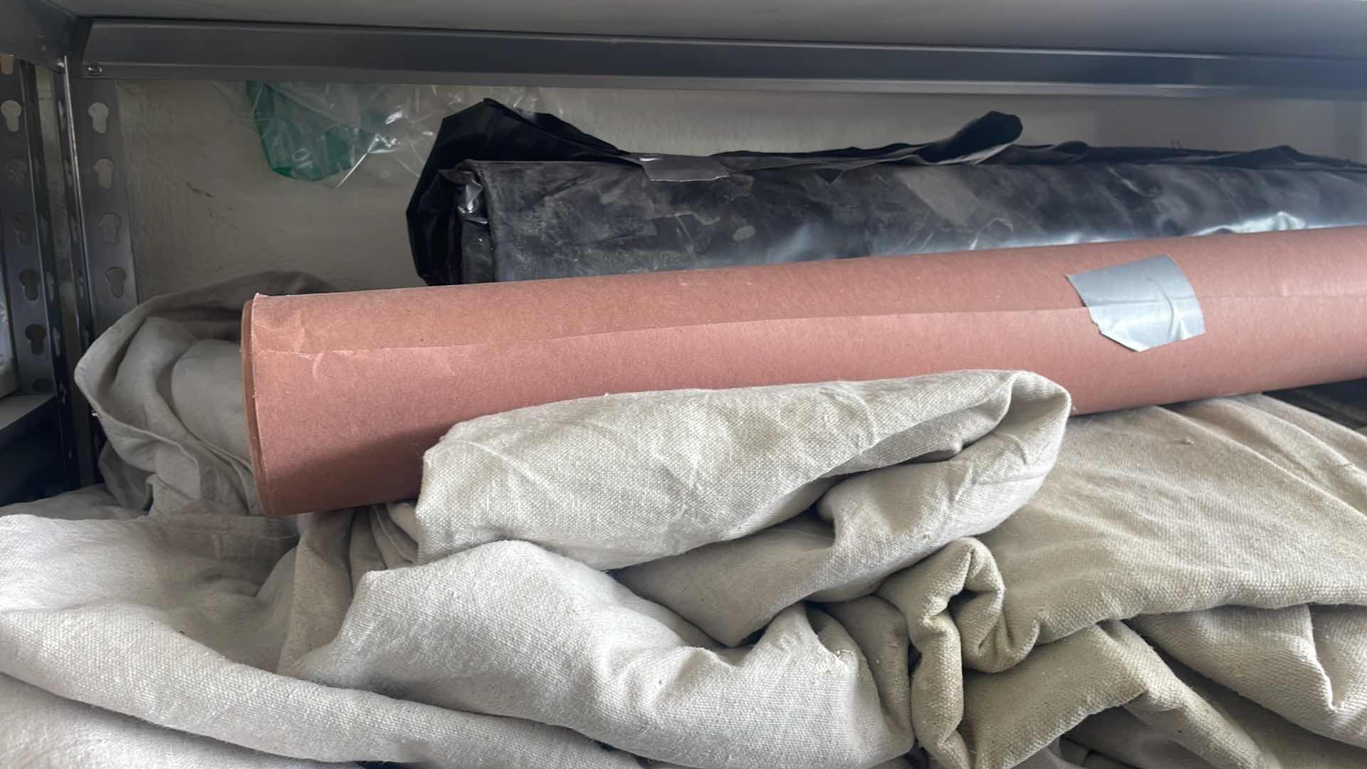 Photo 1 of DROP CLOTHES (6) PAPER ROLL BLACK PLASTIC ROLL UNKNOWN FOOTAGE.