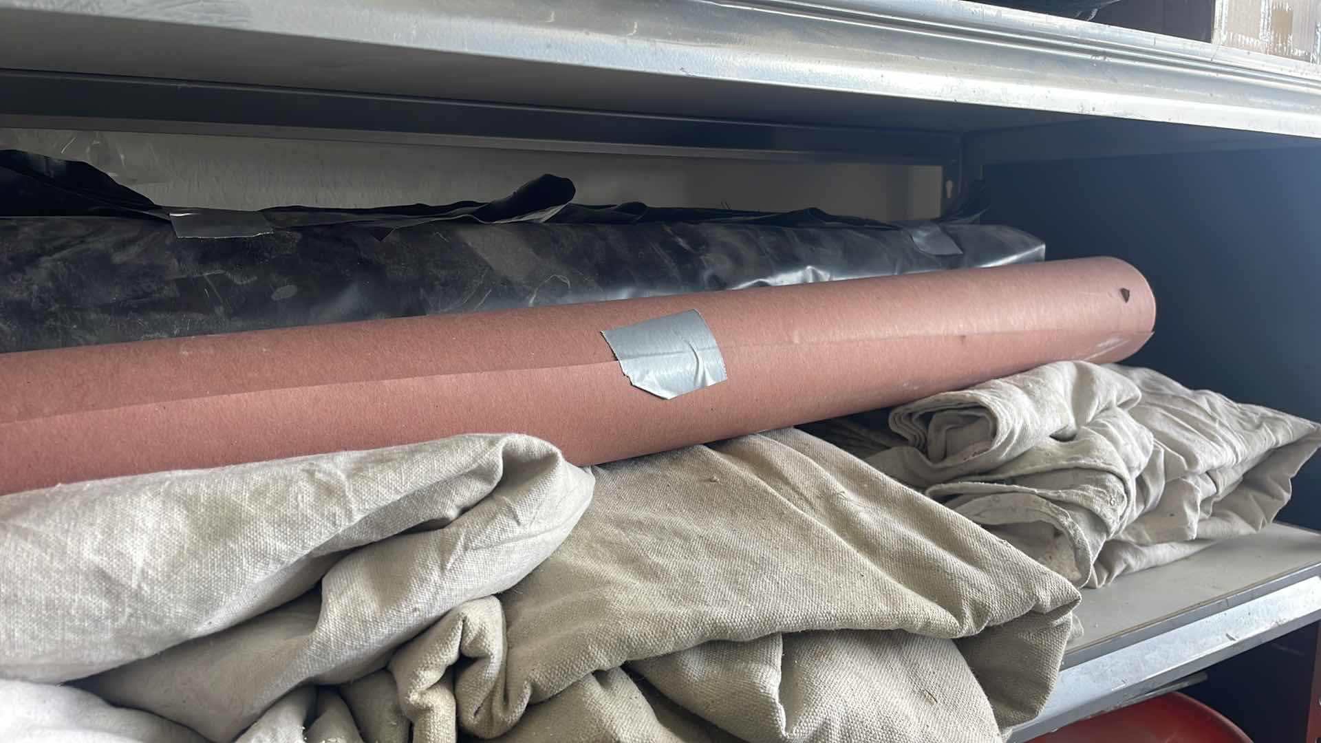 Photo 1 of DROP CLOTHES (6) PAPER ROLL BLACK PLASTIC ROLL UNKNOWN FOOTAGE.