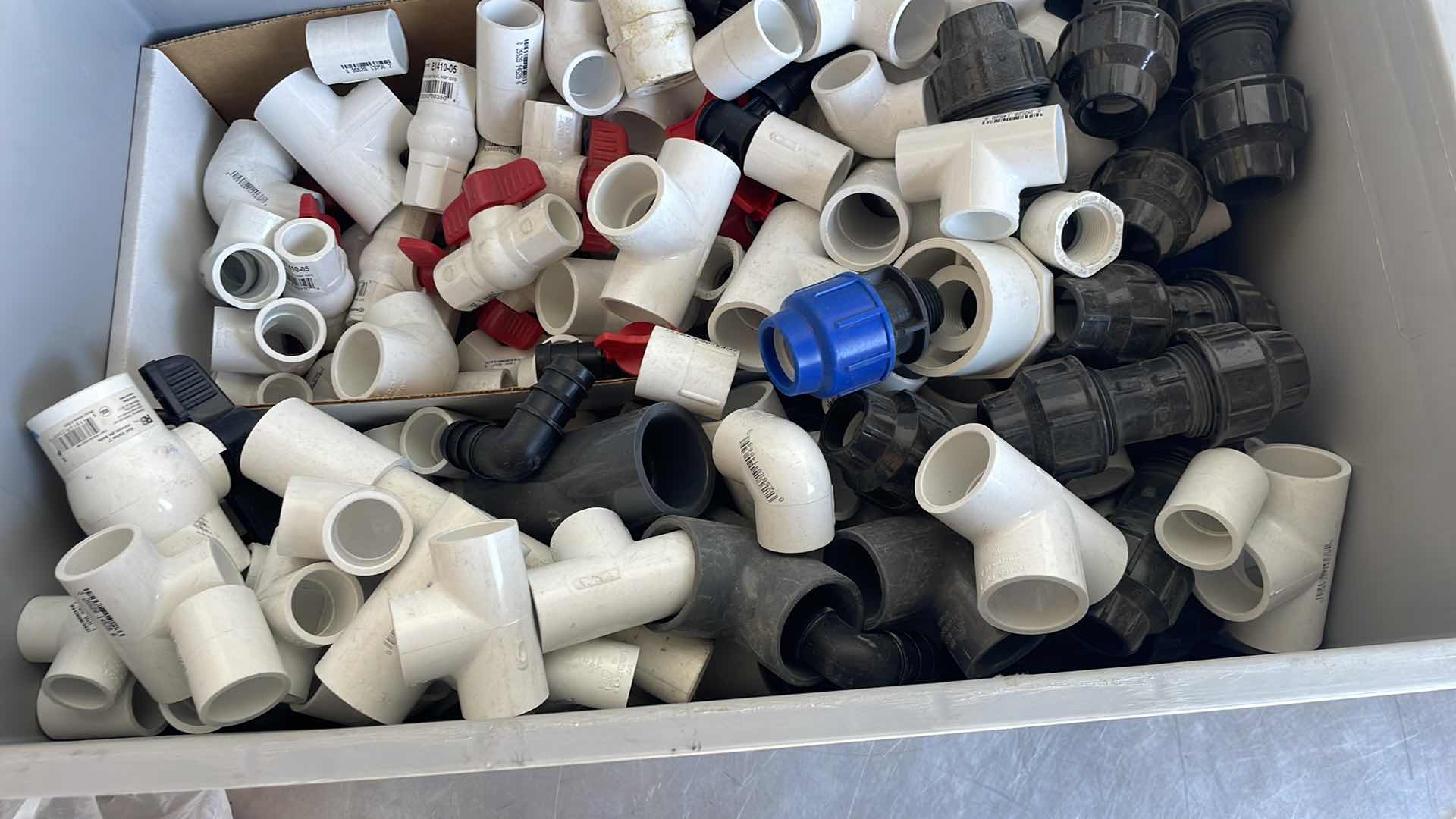Photo 1 of BOXPLUS 24”x16”x17” FULL OF VARIOUS PVC TEES, ELBOWS, JUNCTIONS,  VALVES
