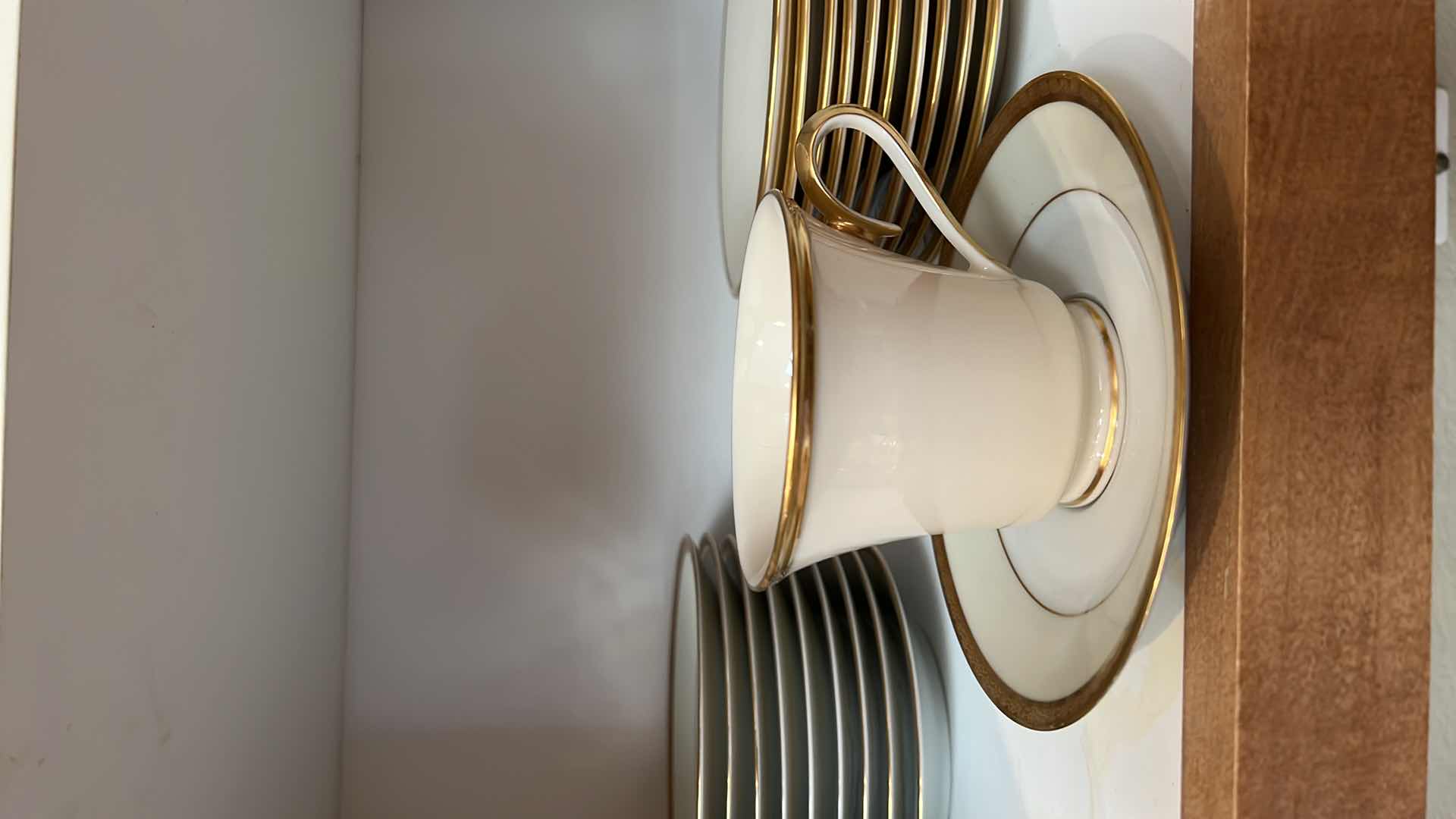 Photo 1 of CONTENTS OF KITCHEN CABINET (LENOX CHINA CUPS AND SAUCERS)