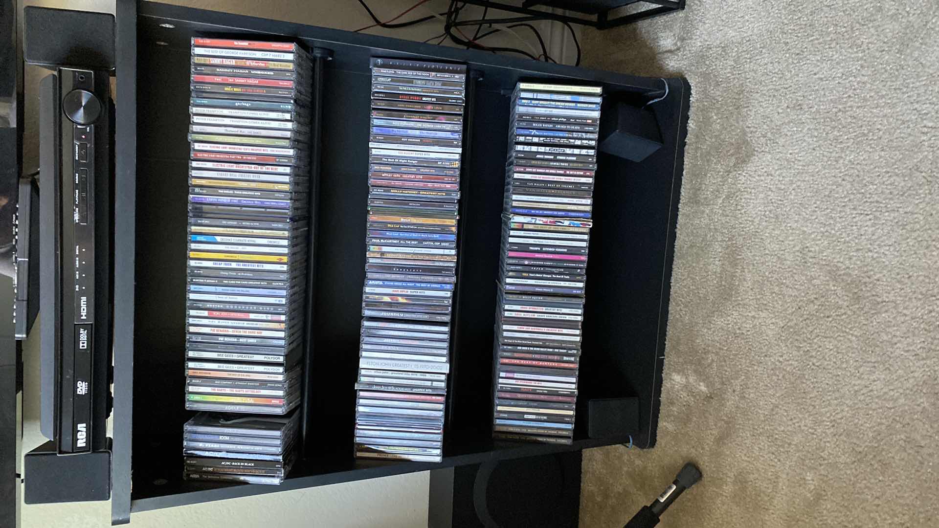 Photo 1 of CD STORAGE UNIT WITH ROCK CDS. 24x10x31H AC/DC JOURNEY PAT BENETAR BOSTON EAGLES PRINCE OZZY & MANY MORE