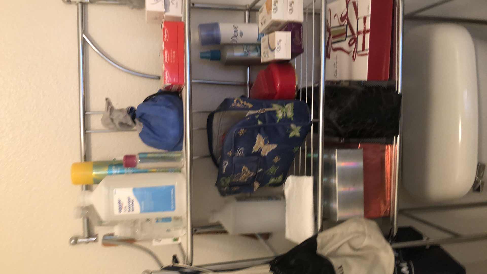 Photo 2 of CONTENTS OF BATHROOM,(EXCLUDING FIXTURES) 
METAL OVER THE TOILET SHELF W/CONTENTS, CLEANING SUPPLIES AND MORE