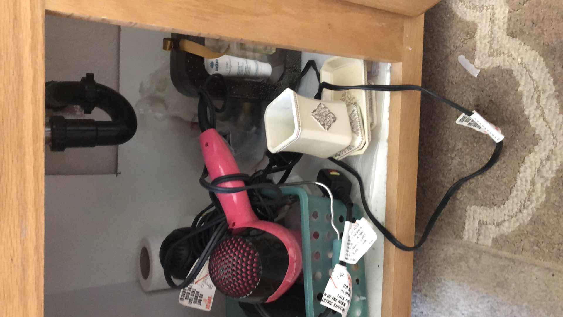 Photo 1 of CONTENTS UNDER BATHROOM SINK INCLUDING RUG, BLOW DRYERS, NEW MAKEUP, TOOTHPASTE AND MORE