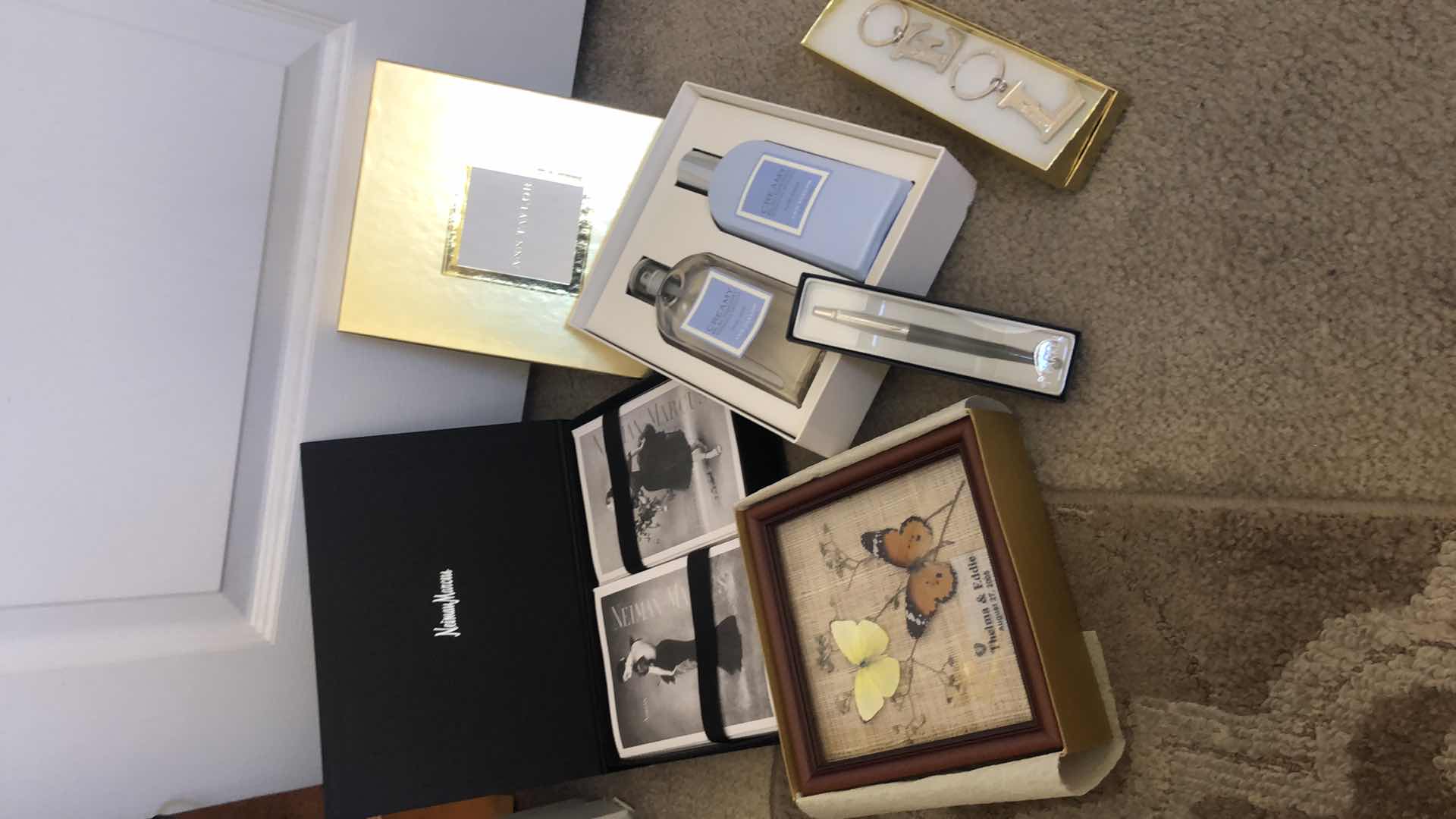 View 1 of NEW NEIMAN MARCUS CARD SET, NEW PARKER PEN, NEW ANN TAYLOR BODY SET, NEW BUTTERFLY ARTWORK AND TWO KEY FOBS.