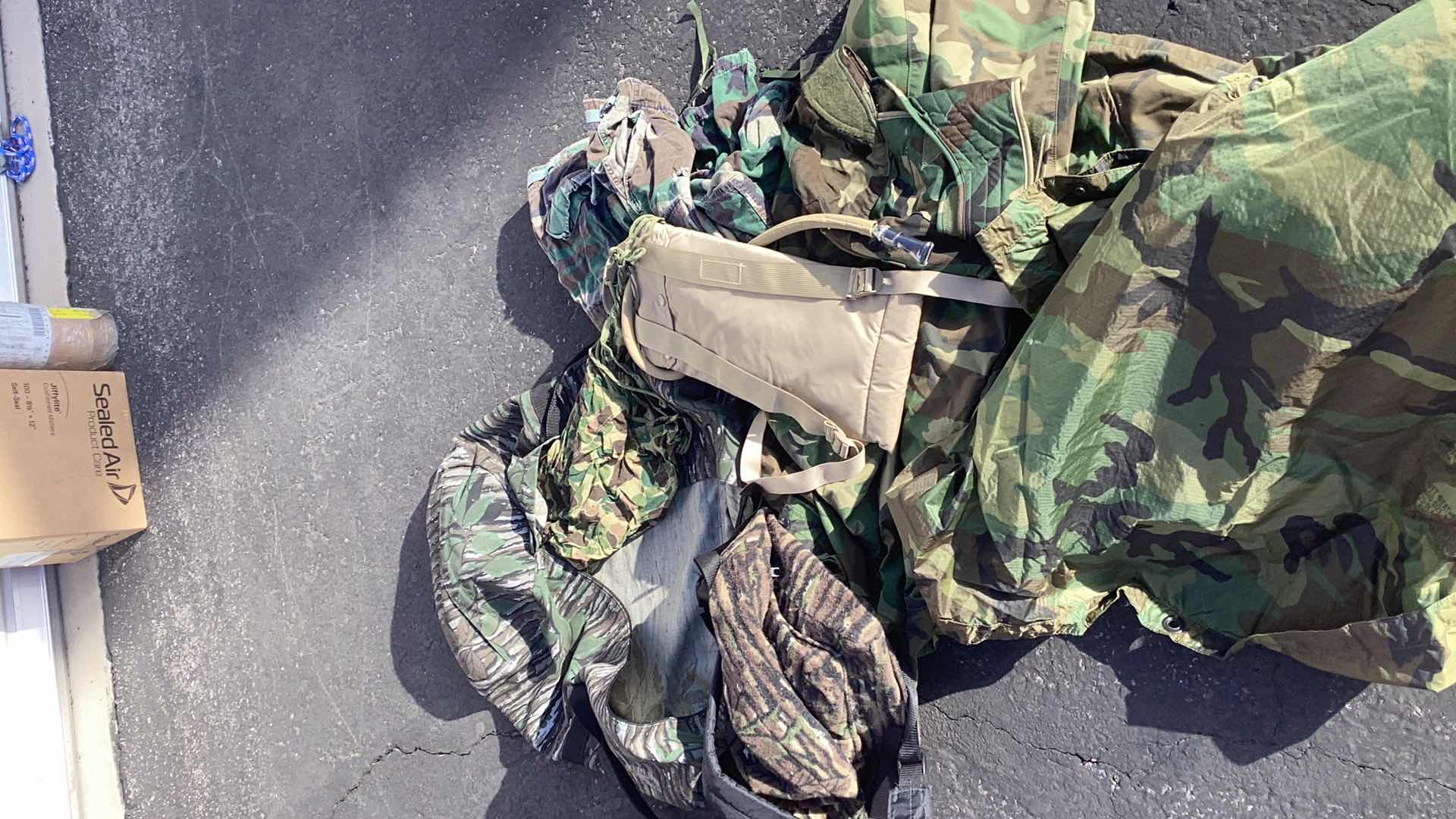 Photo 3 of DUFFLE BAG FULL OF CAMOUFLAGE GEAR AND WATER