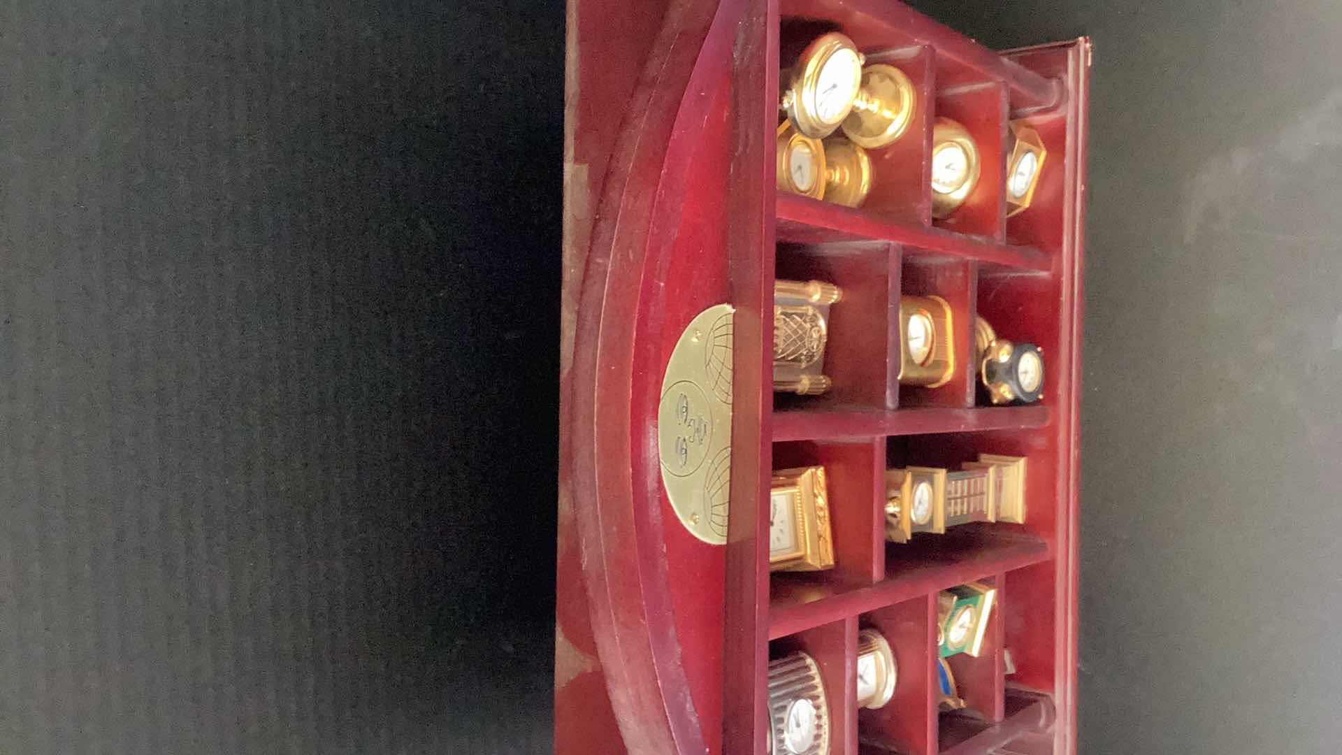 Photo 1 of FIFTEEN MINI CLOCKS IN CASE 14” X 14”