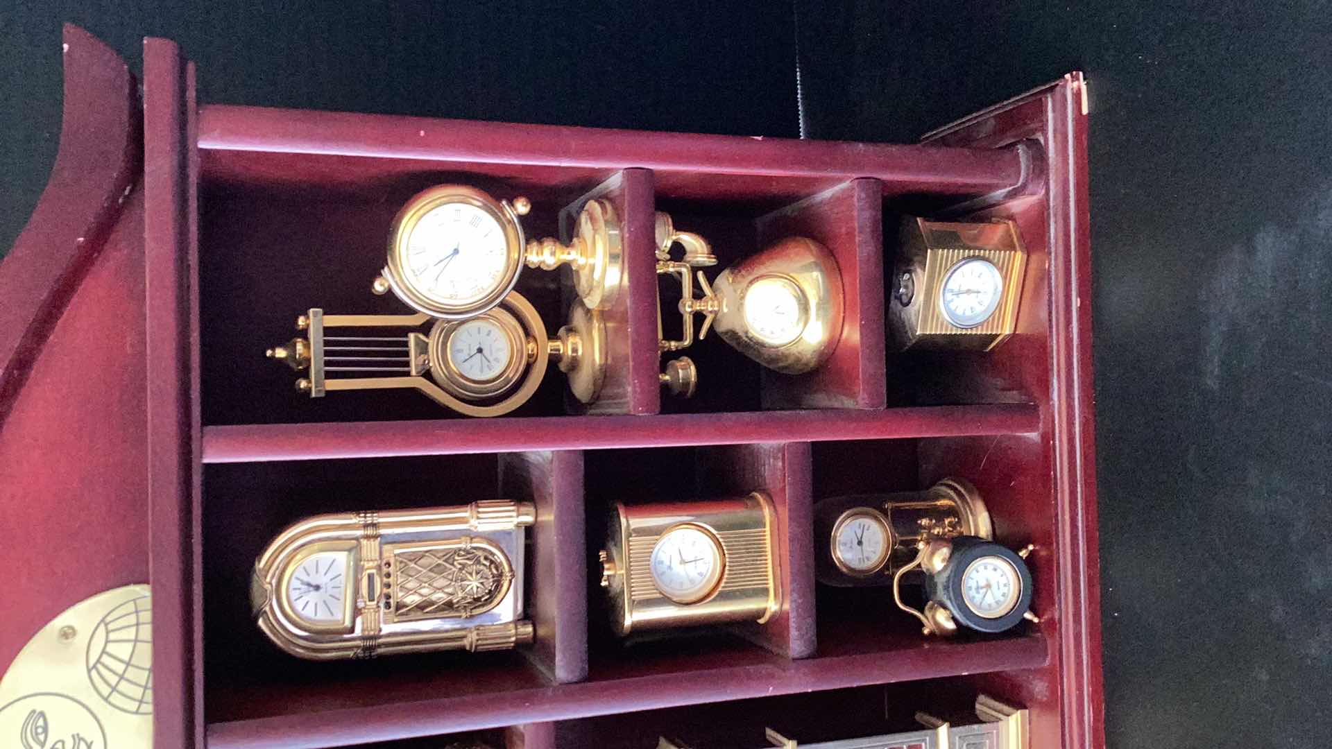 Photo 1 of FIFTEEN MINI CLOCKS IN CASE 14” X 14”