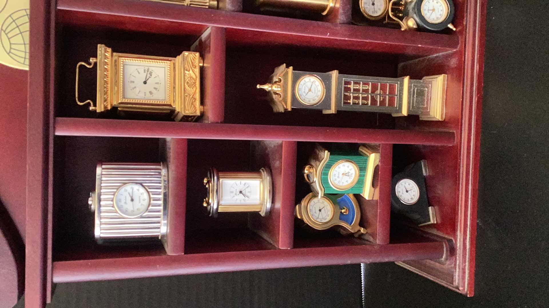 Photo 1 of FIFTEEN MINI CLOCKS IN CASE 14” X 14”