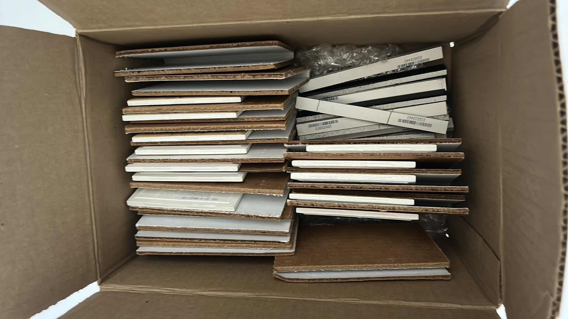 Photo 1 of BOX OF SMALL CERAMIC TILES BY DEBRA OSBURN LIVING CERAMICS AND 3 ROLLS OF WALLPAPER 