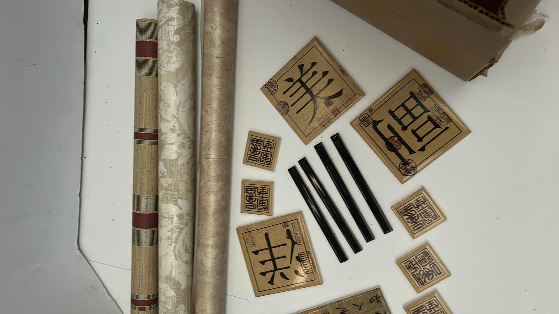 Photo 1 of BOX OF SMALL CERAMIC TILES BY DEBRA OSBURN LIVING CERAMICS AND 3 ROLLS OF WALLPAPER 