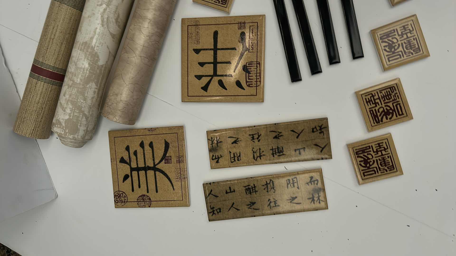 Photo 1 of BOX OF SMALL CERAMIC TILES BY DEBRA OSBURN LIVING CERAMICS AND 3 ROLLS OF WALLPAPER 